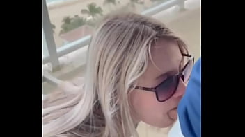 Sexy blonde giving blowjob to her boyfriend in balcony...
