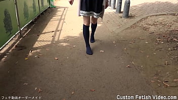 Clip A girl walks on a dirt or sandy road with just socks without wearing shoes