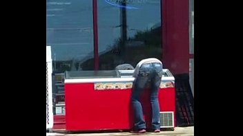 Gas Station Employee cleaning a cooler...