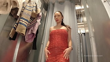 I try on clothes in fitting room with open curtain.