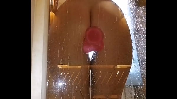 girl with an appetizing ass is having fun in the shower with a pink dick