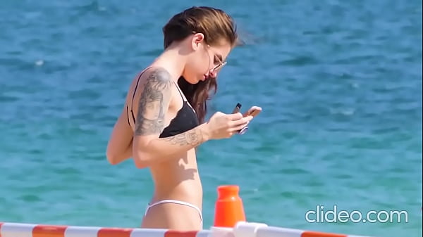 Pretty tattooed teen on the beach Thumbnail