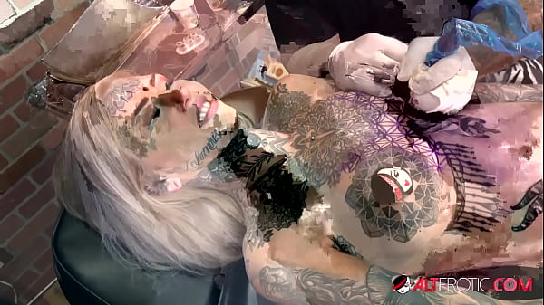 Sascha plays with Amber Luke while she gets tattooed