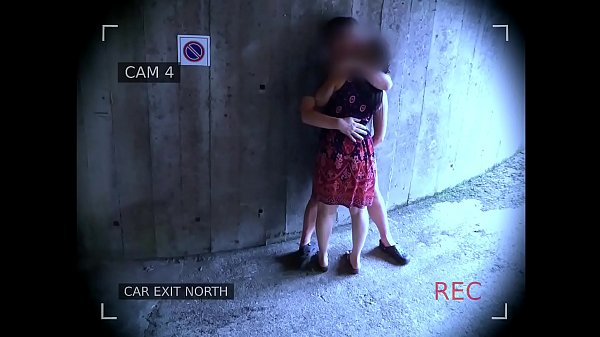 Young couple fucks in front of the garage exit and is caught by the surveillance camera