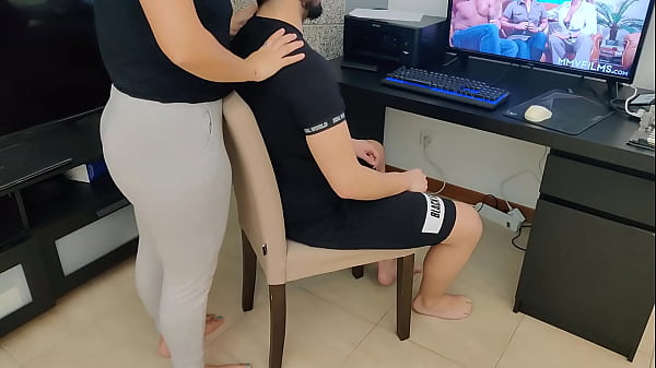 mature gives her stepson a handjob while watching porn