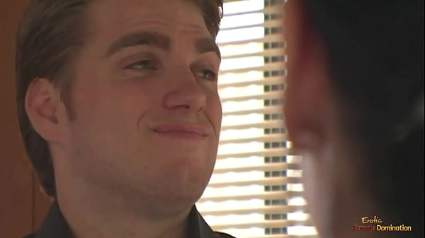 A busty brunette ties a man to the cross and makes him lick her pussy.