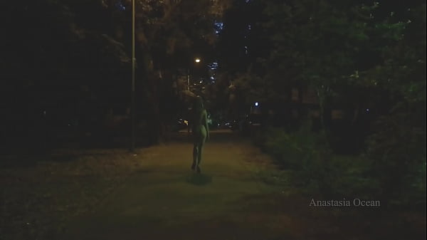 Naked woman walking on the city street in the early morning. Public.