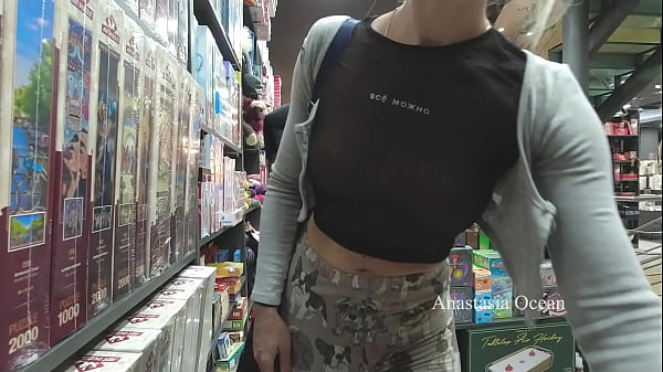 Lady Looking something in transparent top in book store. Flashing in public.