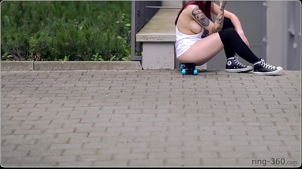 Brunette girl with skateboard flashing in public