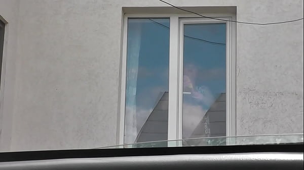 Sexy MILF Frina in dressing gown without panties and bra washes windows of apartment and is not shy about random taxi driver on street who looks out from his car. Naked in public. Nude in public. Public nudity. Publicly. Public. Natural tits Milf.