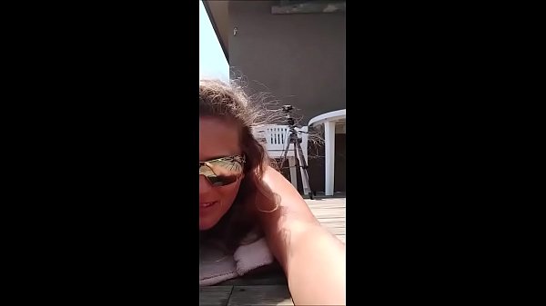 My slut sunbathing on the beach with duct tape bikini