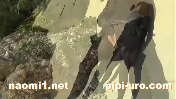 public pissing couple on a beach