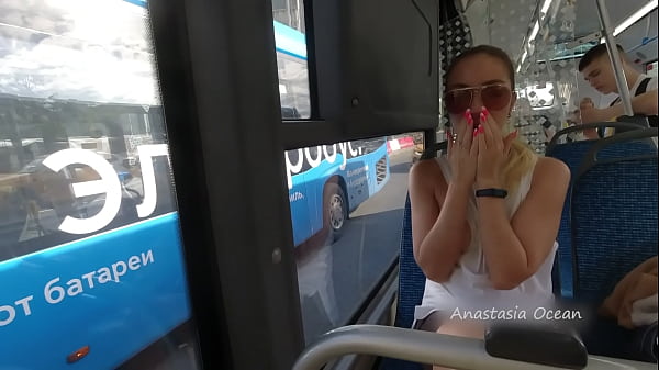 A girl rides a public bus with bare breasts