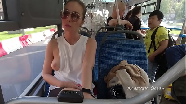 A girl rides a public bus with bare breasts