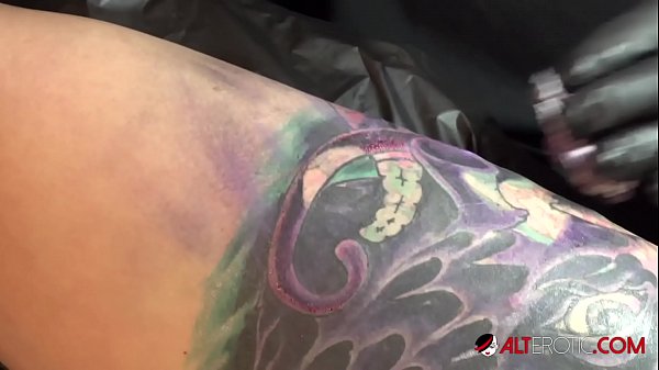 Marie Bossette touches herself while being tattooed