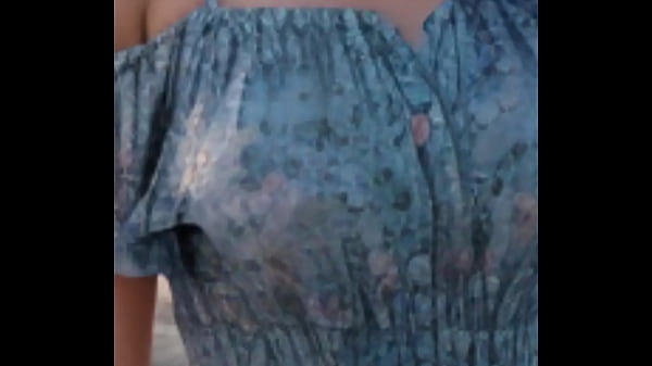 A mature woman takes a walk on the beach. Thumbnail