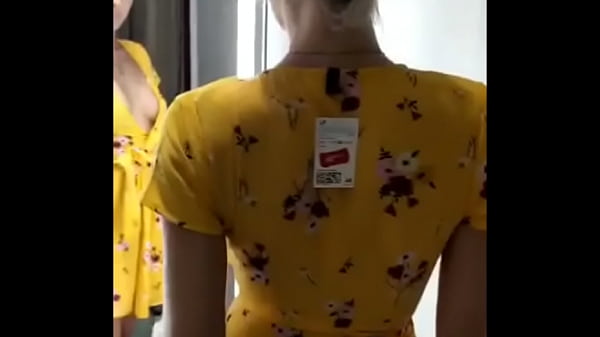 Girl changes clothes in fitting room.
