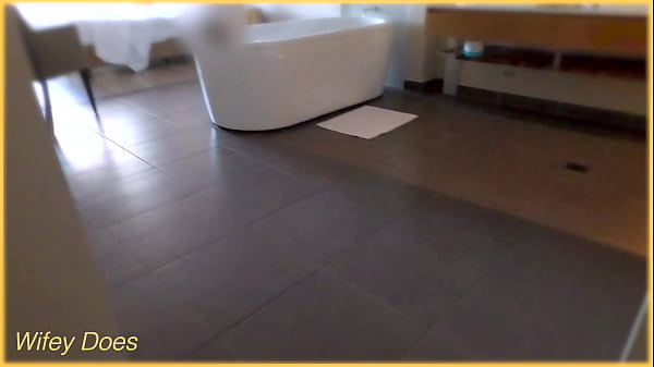 Wife gets all wet in the hotel bath with her big tits