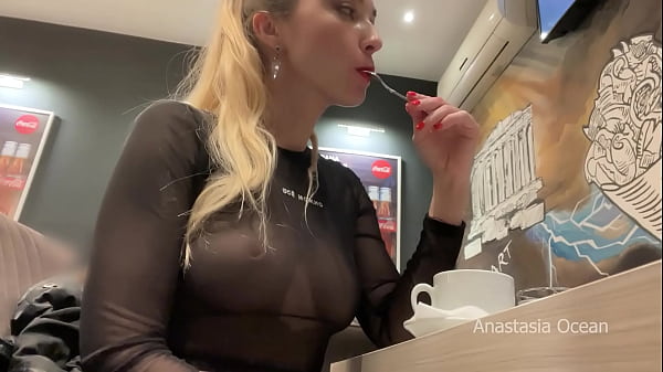 Flashing her big boobs in transparent top in public cafe.