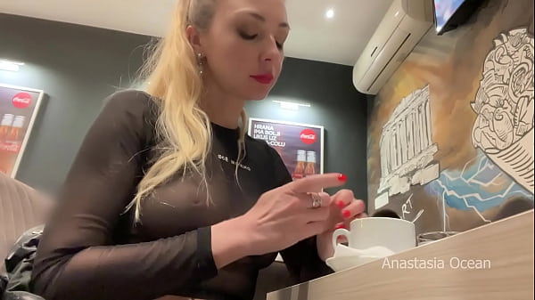 Flashing her big boobs in transparent top in public cafe.