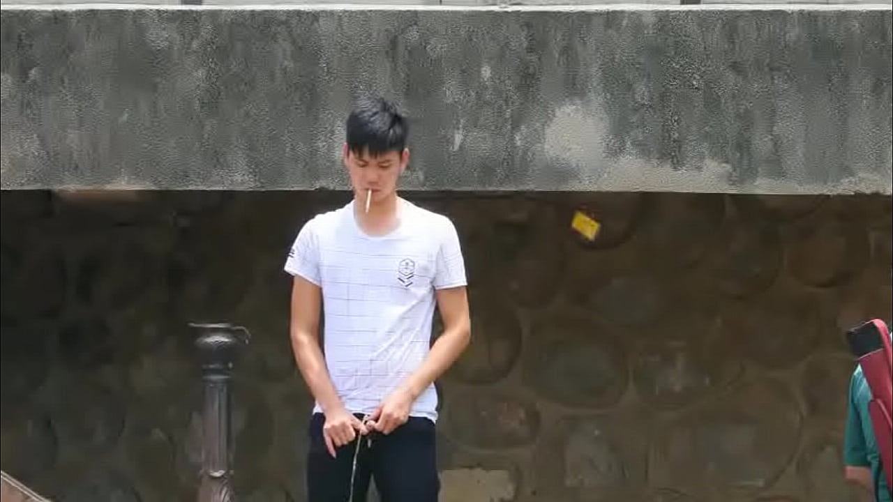 boy outside pissing 