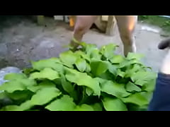  - Couple pissing together on a plant