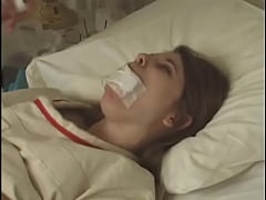  - Pretty brunette in Straitjacket taped mouth tied to bed hospital