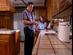  - Young redhead slut is on her knees sucking older stud's dong in the lkitchen