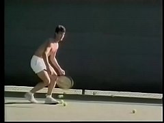 Tennis player likes to loosen his penis stiff muscles after excercises with ball shooter machine and drop his load on his tennis racket